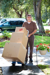 Delivery man or mover bringing boxes up your front walk.   Man With Van Tufnell Park 126 Fortess Rd 