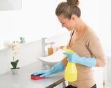 Housewife cleaning desk in bathroom Cleaning Services Toronto Pro 1075 Bay Street #102A 