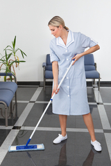 Maid Cleaning The Floor With Mop In Office
