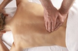 massage of the lower back on white linen, Body Development Centre, Groby