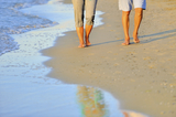 close-up of a romantic couple walking together along the beach
