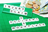 workplace accident injury claim spelled out of scrabble pieces, Law Office of Tawni Takagi, Canoga Park
