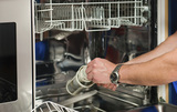 Technician repairing the dishwasher