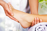 Foot massage in the spa salon in the garden