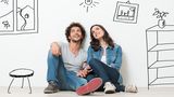 Portrait Of Happy Young Couple Sitting On Floor Looking Up While Dreaming Their New Home And Furnishing iMortgageBroker Inc. - Dominion Lending Centres 415 Wharncliffe Rd S 
