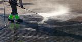  Wet cleaning of street with pressurized water.