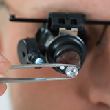 Close-up Of Person Looking At Diamond With Magnifying Loupe Mark Diamond’s Jewelers 8000 Paseo Del Norte NE Suite B-1 