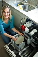 Pretty blonde woman emptying the dishwasher in the kitchen, Appliance Repair Experts ASAP, Berwyn