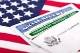 20947903 - united states of america social security and green card with us flag on the background  immigration concept  closeup with shallow depth of field