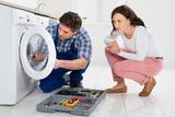 Repairman Repairing Washer In Front Of Young Woman In Kitchen At Home, Reliable Appliance Repair Solutions, Arlington Heights