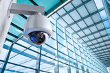 Security, CCTV camera for office building at night in London.