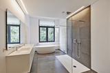 Bathtub in corian, Faucet and shower in tiled bathroom with windows towards garden, Bison Electrical Limited, London