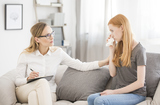 Medical concept, female psychologist comforting teenage girl with anxiety disorder