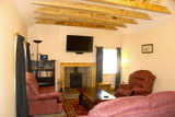 Lounge in Buxa Croft with wood burning stove and large screen Blu Ray TV Buxa Farm Chalets & Croft House A964 