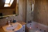 Ensuite bath with shower over jacuzzi tub Westrow Lodge Bed & Breakfast A964 