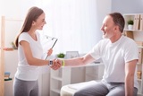 Be in good health. Cheerful and happy female physiotherapist shaking hands with a patient sitting in the medical office Restore Movement Physiotherapy 509 Warrigal Rd, Ashwood VIC 3147, Australia 