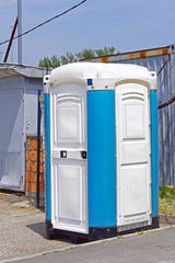 Portable toilet cabin at open construction site