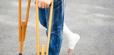 closeup of leg on bandage with crutches