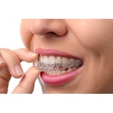 Woman wearing orthodontic silicone trainer. Invisible braces