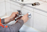 Plumber hands fixing water  tap with spanner Loodgieter RVH Onderhoud Rotterdam Benthuizerstraat 85-C 